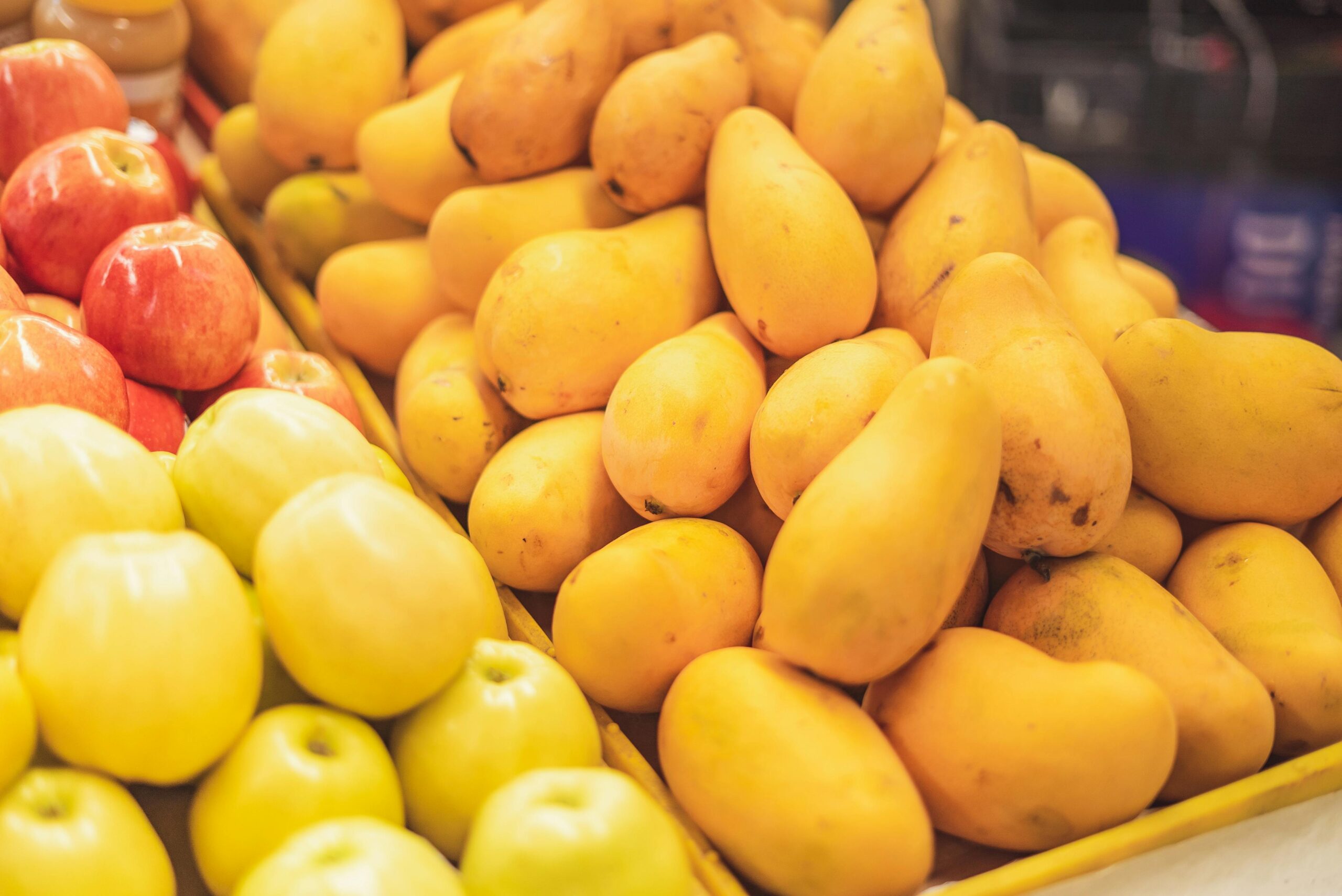 pexels photo 8446853 8446853 A vibrant display of fresh apples and mangoes in a supermarket's fruit section.