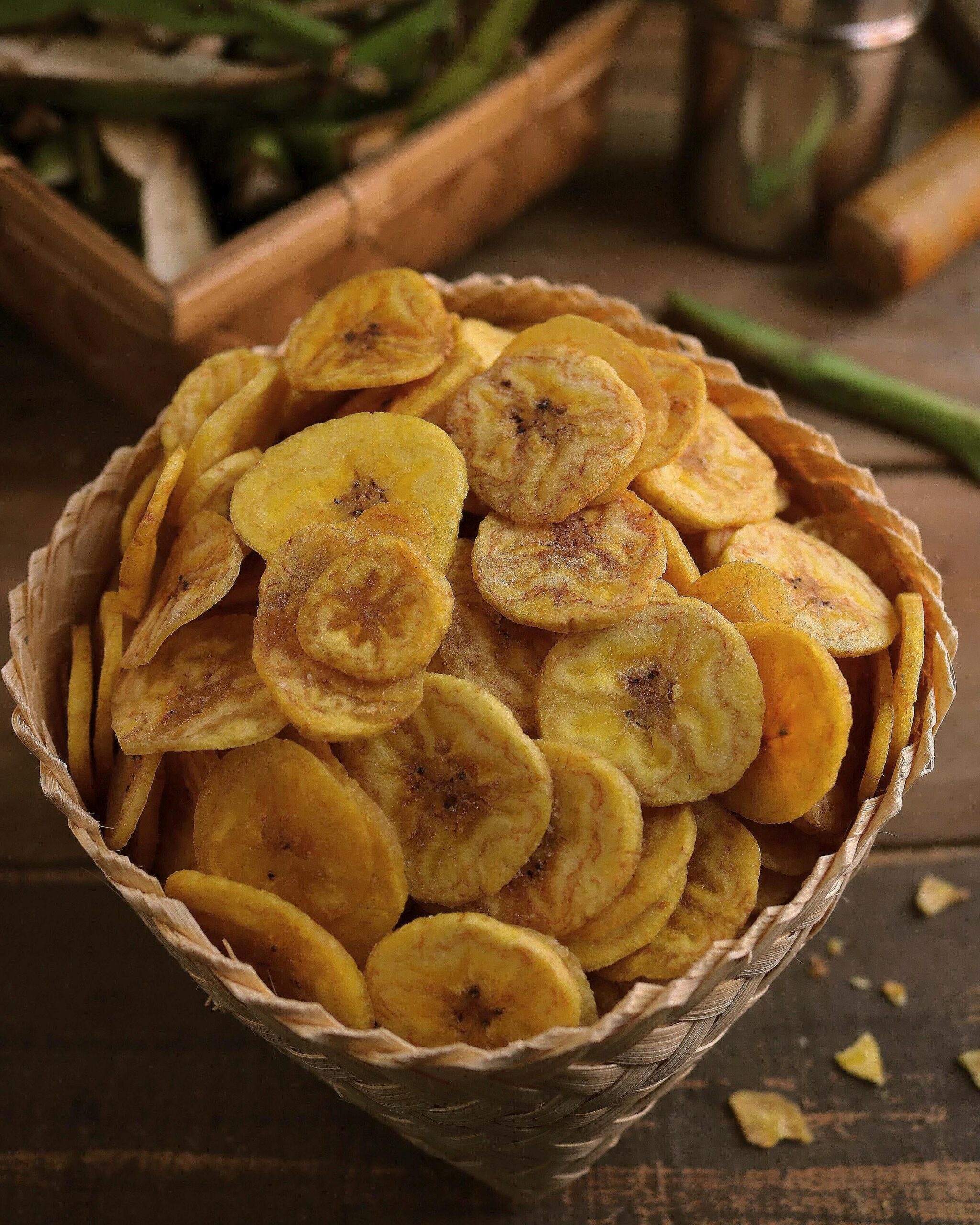 pexels photo 9191924 9191924 Delicious crispy banana chips in a rustic woven basket, perfect snack for any occasion.